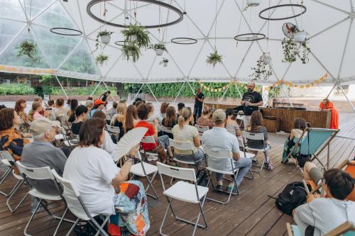 Teenagers, parents, and facilitators participate in a plenary session during the Kid Friendly Summer Lab in Odesa, Ukraine.