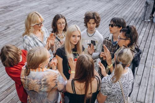 Teenagers and facilitators participate in a group communication exercise during the Kid Friendly Summer Lab in Odesa, Ukraine.