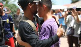 Two men embracing each other