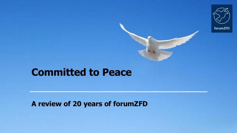 A white peace dove is flying in a blue sky