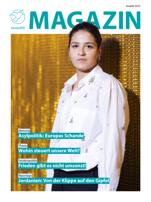 Titelbild des Magazins Ausgabe 3 2023. Eine junge Frau in wei&szlig;er Bluse vor einem gold schimmernden Vorhang