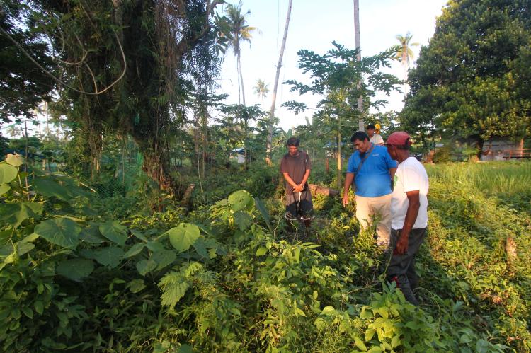 Ustadh Akmad inspecting boundary markers