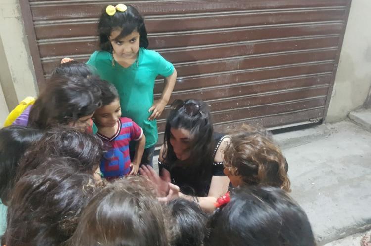 Kids playing with a community activist