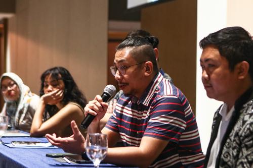 Karlos Manlupig on panel on media