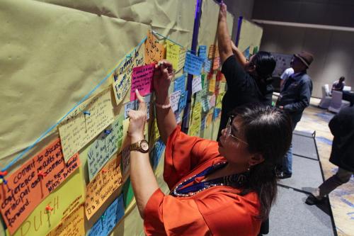 Participant pins her commitment card to the TJ bridge