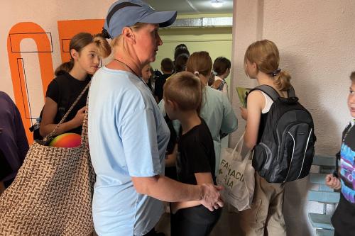 Sch&uuml;ler*innen und Lehrkr&auml;fte vor dem Eingang des Luftschutzkellers.