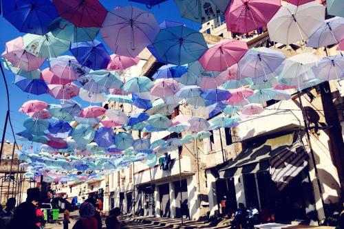 Colorful umbrellas hanging above a street
