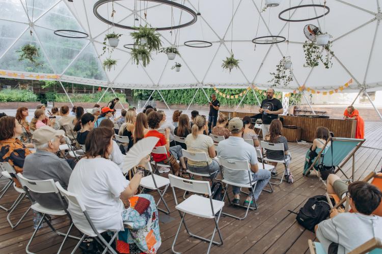 Teenagers, parents, and facilitators participate in a plenary session during the Kid Friendly Summer Lab in Odesa, Ukraine.