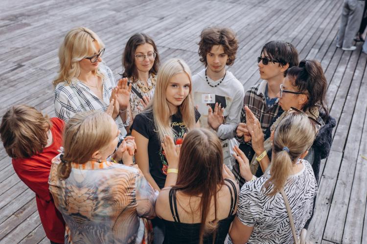 Teenagers and facilitators participate in a group communication exercise during the Kid Friendly Summer Lab in Odesa, Ukraine.