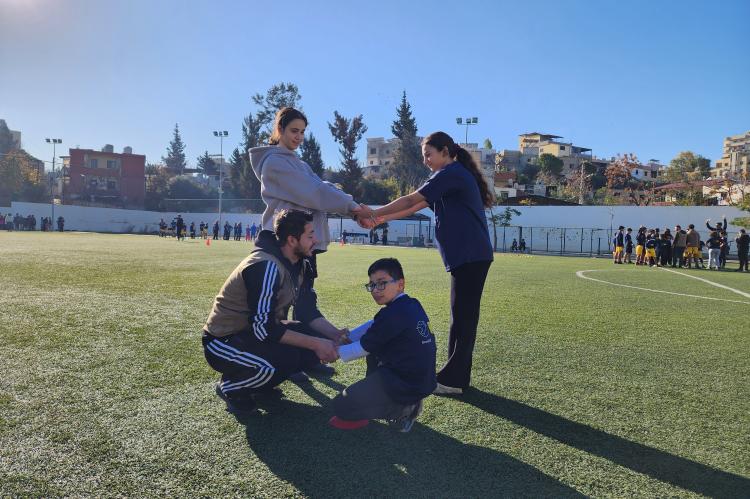 A coach with kids in the field