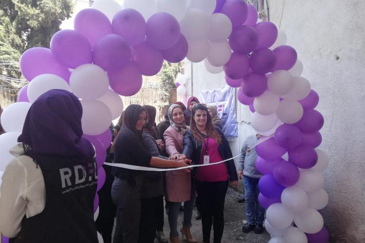 Opening of centre, group of women sorrounded by balloons