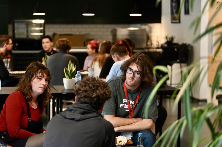 A group of a young artists hold a conversation.