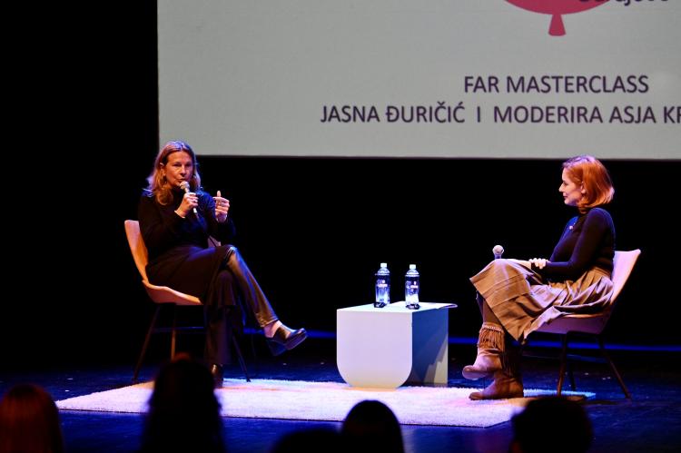 Two female artist hold a stage conversation.