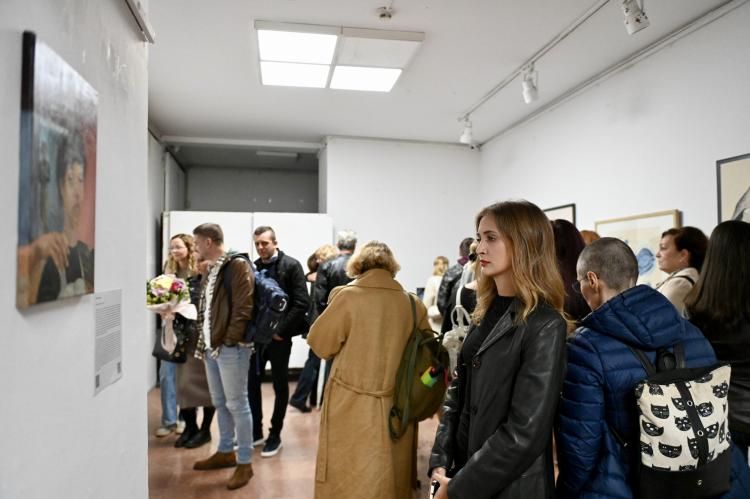 A young woman observes an artworm presented in the exhibition.