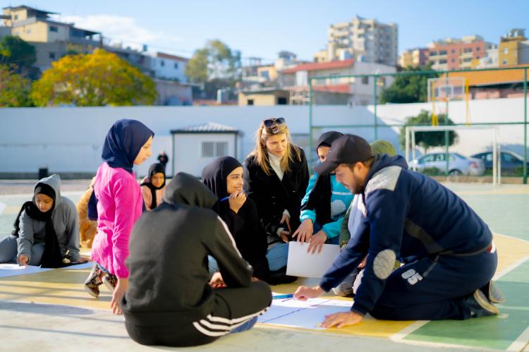 Coach teaching peace education exercises