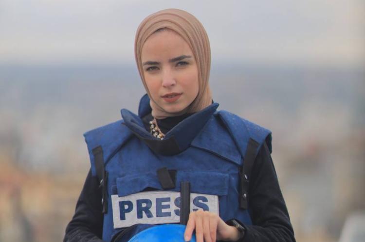 Ma'ather poses in a Security West labeled "PRESS"