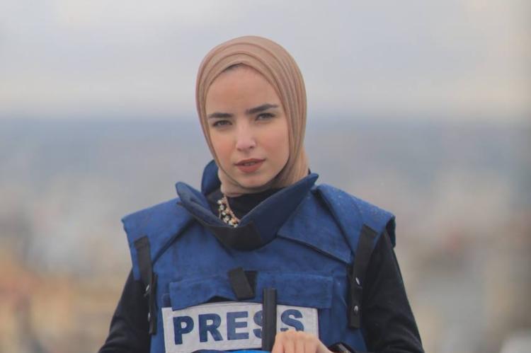 Ma'ather poses in a Security West labeled "PRESS"