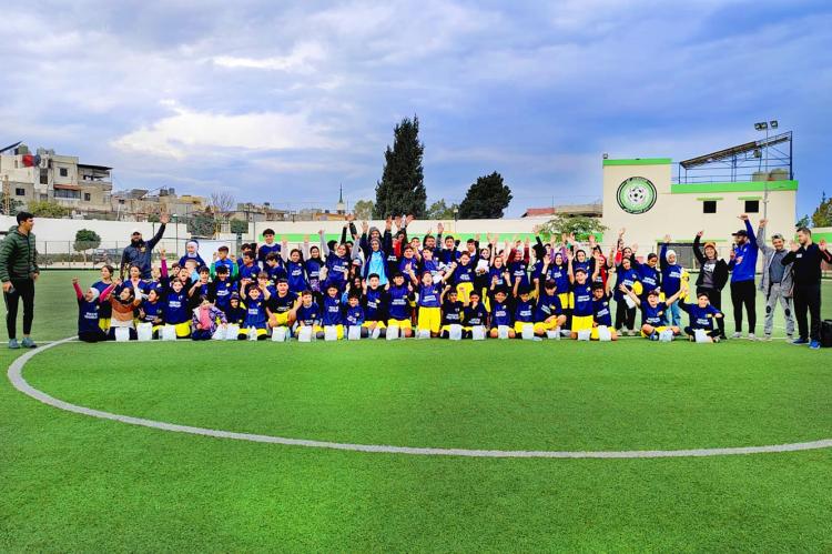 Sports for Peace group photo with coaches and children during the closing ceremony