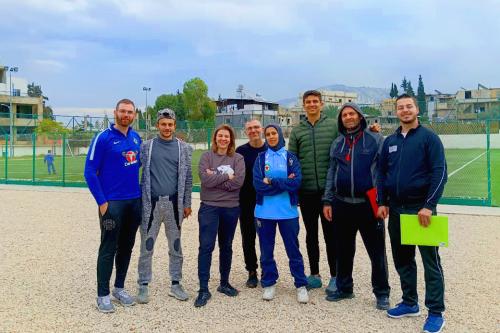 Sports for Peace coaches standing together on the field