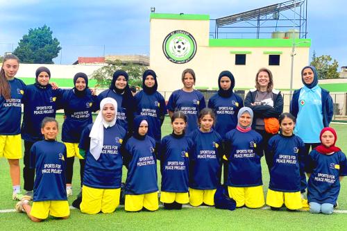 The Sports for Peace girls team taking a group photo together