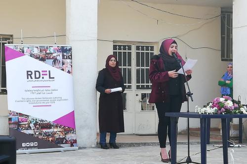 Woman on stage holding a speech 