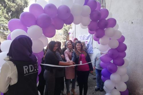 Opening of centre, group of women sorrounded by balloons