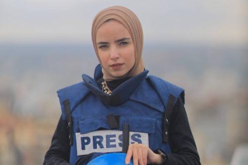 Ma'ather poses in a Security West labeled "PRESS"