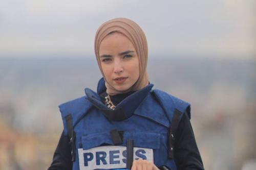 Ma'ather poses in a Security West labeled "PRESS"