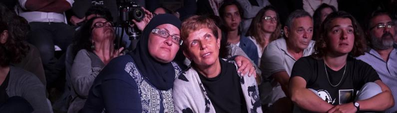 Two women hugging each other during the Joint Memorial Day