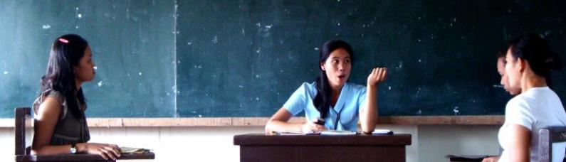 Three students discussing in a classroom