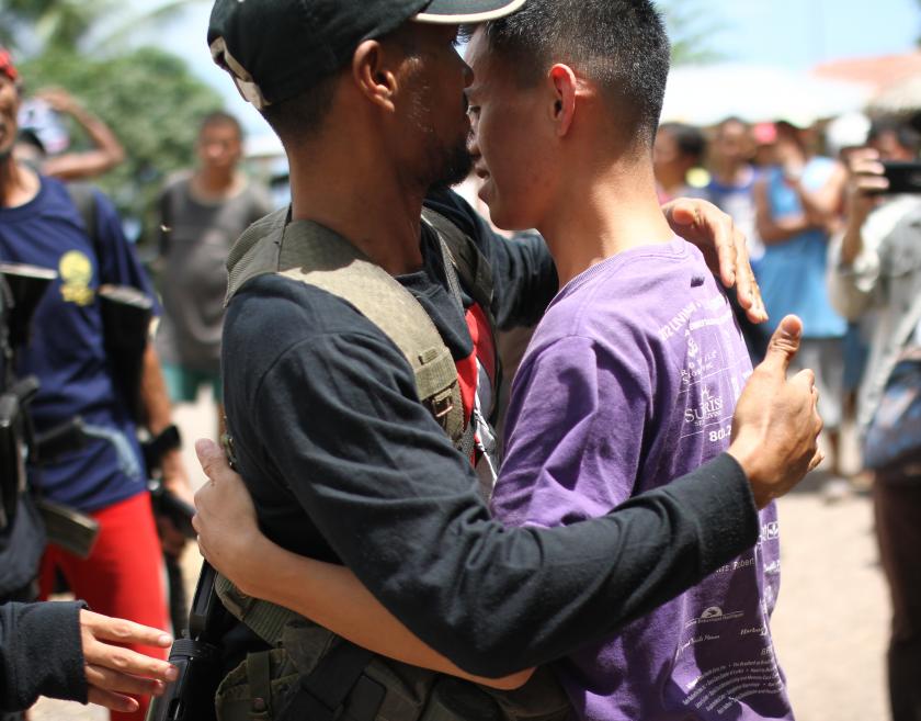 Two men embracing each other