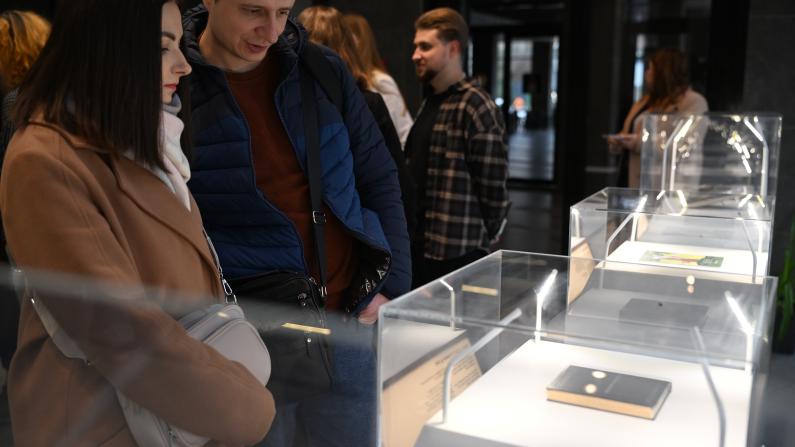 Visitors exploring the exhibition &ldquo;Books That Accompany Through War&rdquo; and its displays