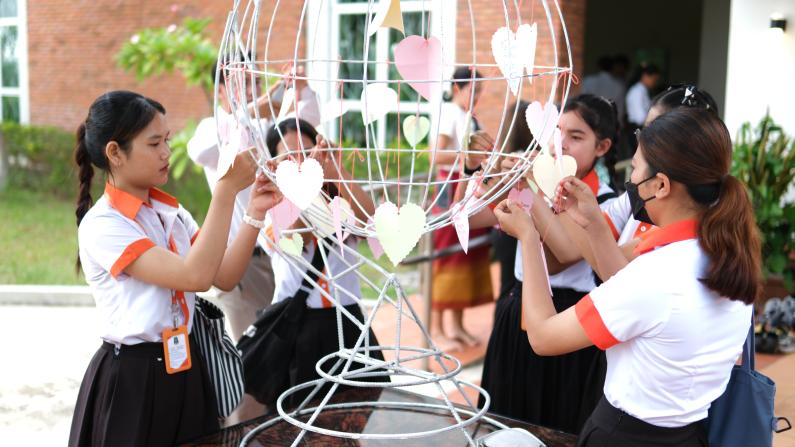 Students from diverse groups created peace symbols togeher.