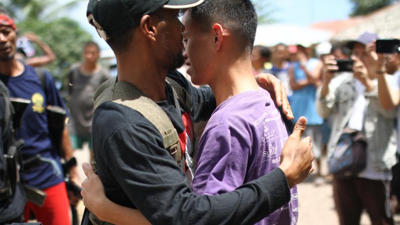 Two men embracing each other
