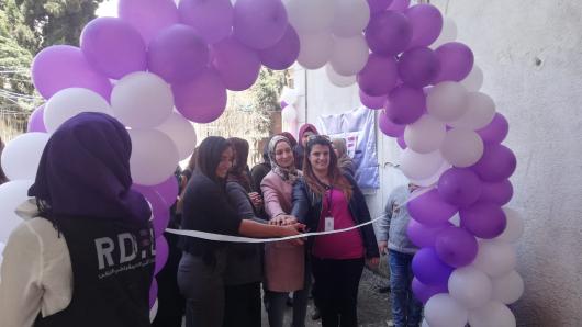 Opening of centre, group of women sorrounded by balloons
