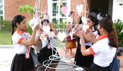 Students from diverse groups created peace symbols togeher.