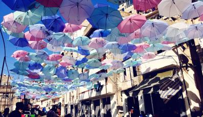 Colorful umbrellas hanging above a street
