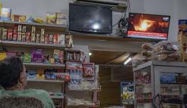 Nachrichten &uuml;ber Bombenangriffe laufen auf Fernseher in Kiosk